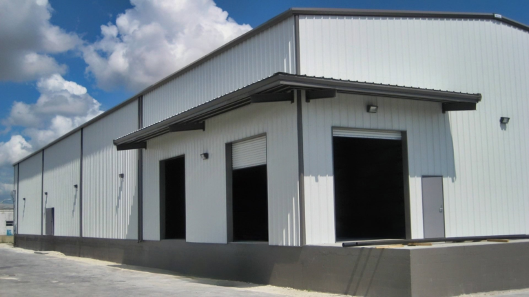 Commercial steel warehouse and industrial metal building with loading bay doors by Turn Key Building Finder
