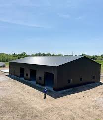 Aerial view of a custom metal shop building with multiple garage bays and engineered steel construction